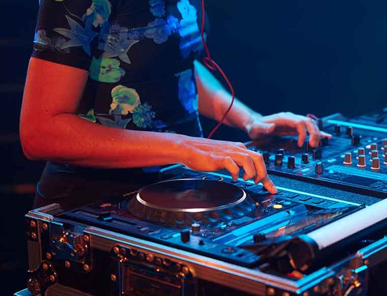 Person mixing and producing electronic sounds