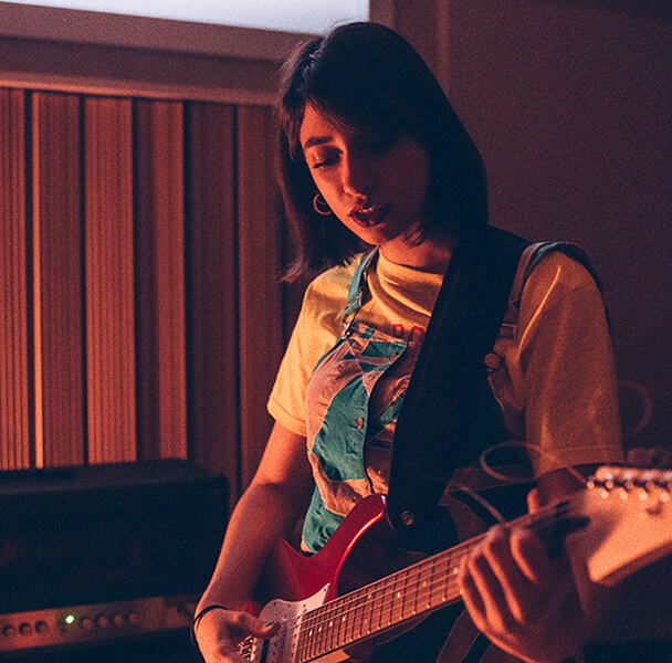 Musician on electric guitar in studio